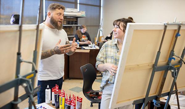 Teacher and student working in art studio